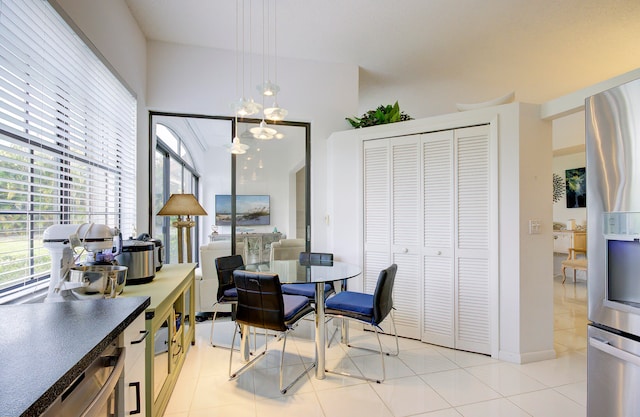 dining room with light tile patterned floors and a chandelier