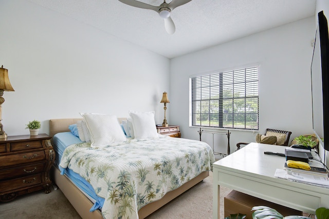 bedroom featuring ceiling fan, carpet floors, and a textured ceiling