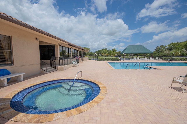 view of pool featuring a gazebo, a hot tub, and a patio area