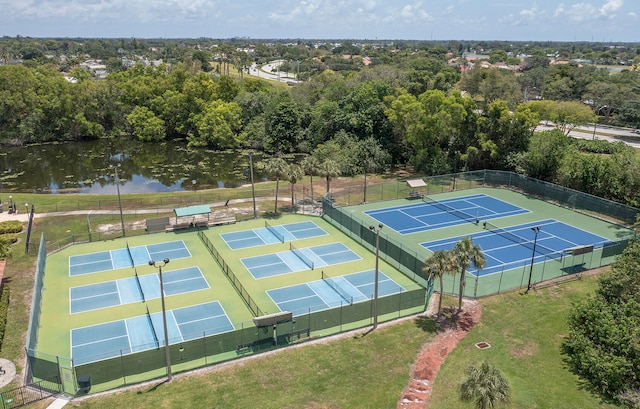 view of tennis court with a water view