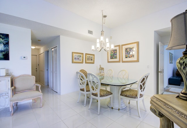 tiled dining area with a chandelier