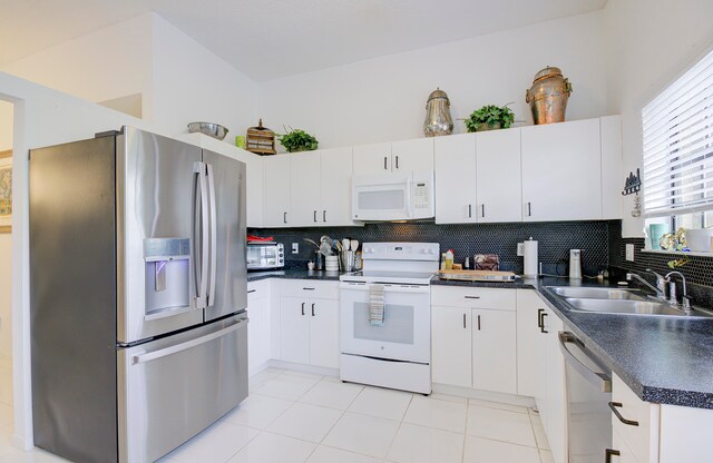 kitchen featuring stainless steel appliances and white cabinetry