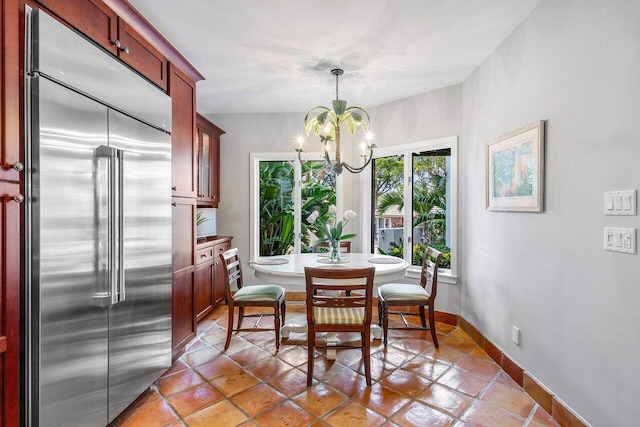 tiled dining room featuring a chandelier