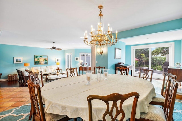 tiled dining room with ceiling fan with notable chandelier