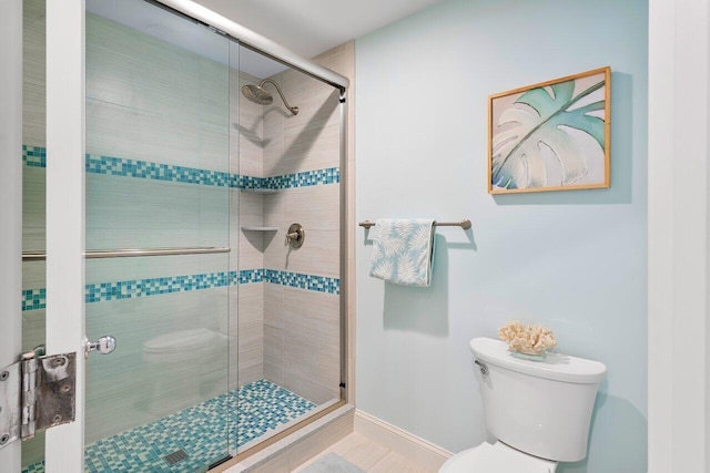 bathroom featuring walk in shower and toilet