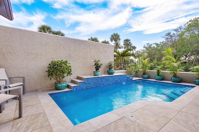 view of swimming pool with a patio area and pool water feature