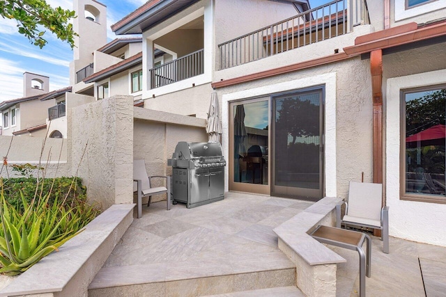 view of terrace with area for grilling and a balcony