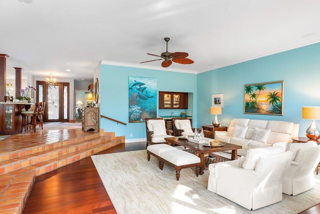 living room with wood-type flooring, ceiling fan, and crown molding