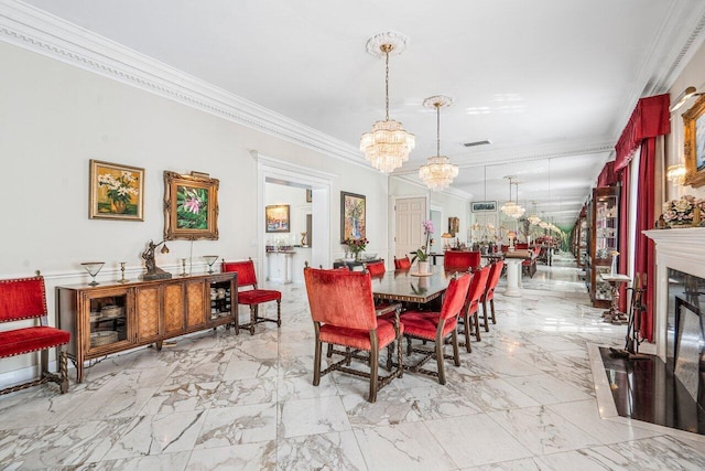 tiled dining area with ornamental molding, a chandelier, and a fireplace