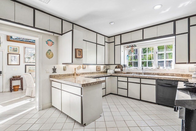 kitchen featuring black dishwasher, light tile floors, and white cabinetry