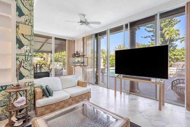 tiled living room with ceiling fan and expansive windows