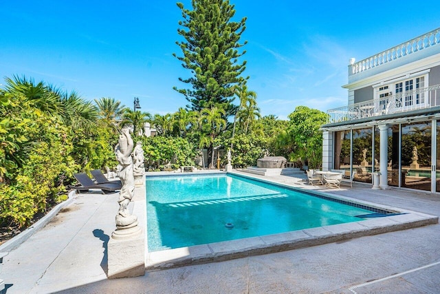 view of swimming pool with a patio