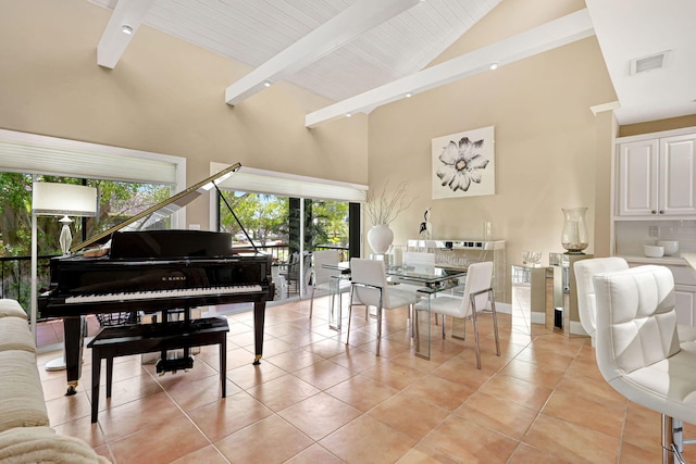 misc room with a wealth of natural light, beam ceiling, high vaulted ceiling, and light tile flooring