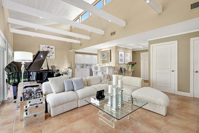 tiled living room with beamed ceiling and a towering ceiling