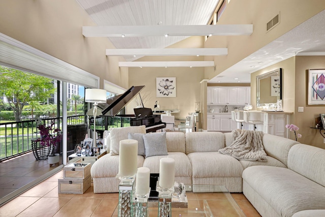 tiled living room featuring high vaulted ceiling and beamed ceiling