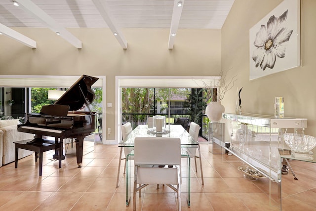 tiled dining room featuring beamed ceiling and high vaulted ceiling