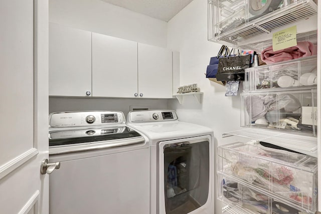 laundry room featuring cabinets, separate washer and dryer, and a textured ceiling