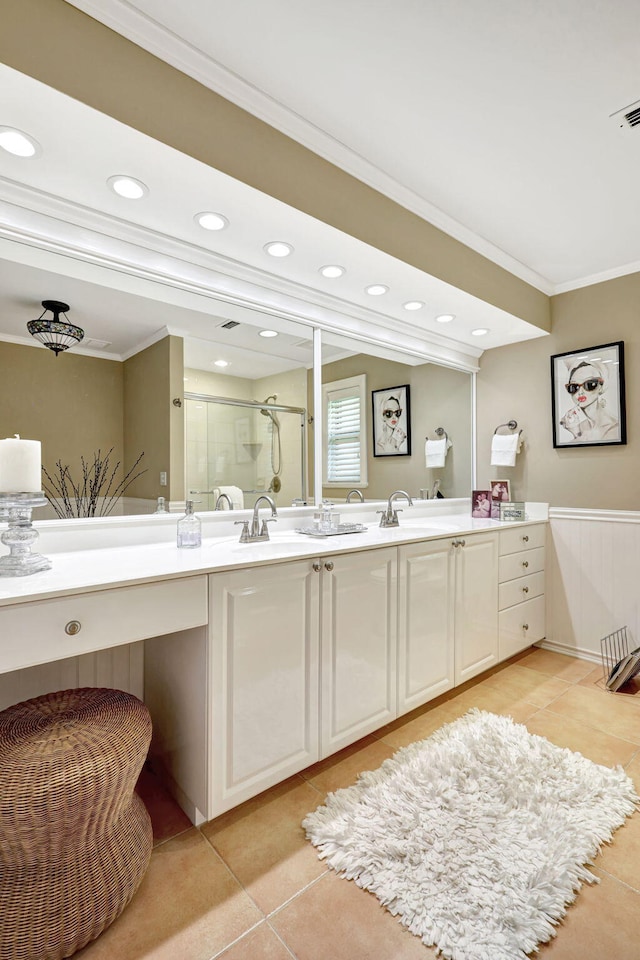 bathroom with double vanity, crown molding, and tile floors