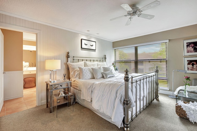 carpeted bedroom featuring ceiling fan, crown molding, connected bathroom, and multiple windows