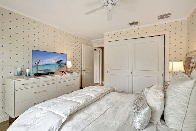 bedroom with a closet, ceiling fan, and crown molding