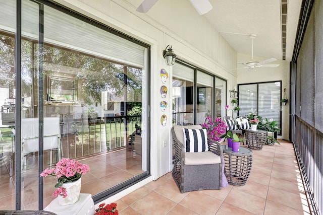 sunroom featuring vaulted ceiling and ceiling fan