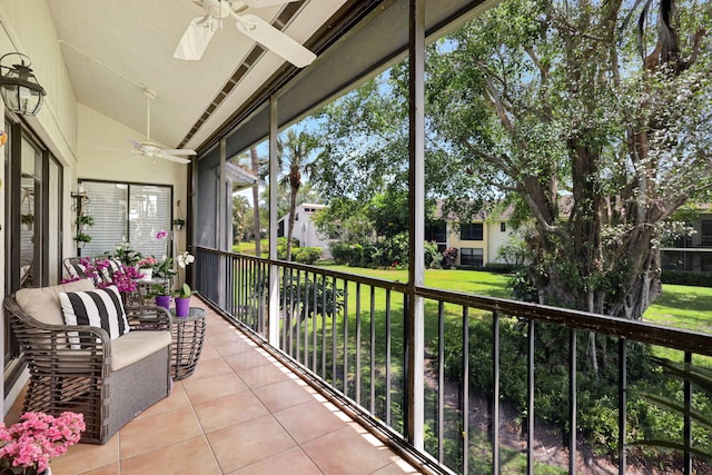 sunroom featuring lofted ceiling and ceiling fan