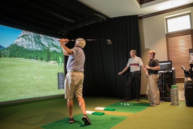 rec room with crown molding, golf simulator, and carpet floors