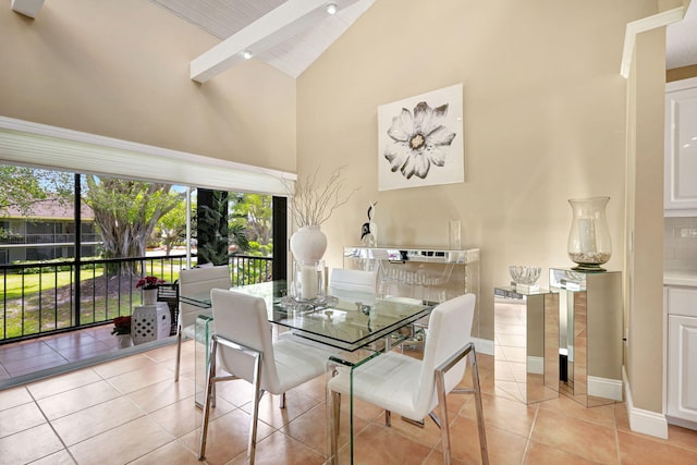 tiled dining room featuring high vaulted ceiling and beam ceiling