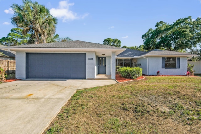 ranch-style house featuring a front lawn and a garage