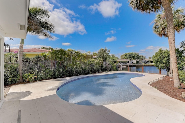 view of pool featuring a patio area and a water view