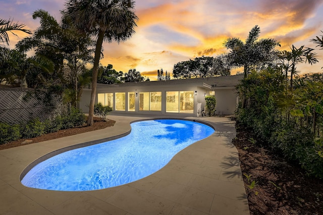 view of pool at dusk