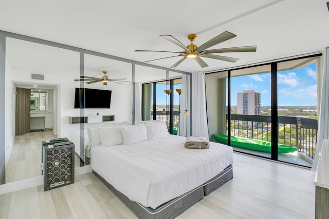 bedroom featuring floor to ceiling windows, ceiling fan, light wood-type flooring, and access to exterior