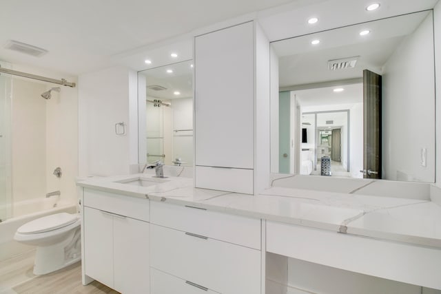 full bathroom featuring shower / bathing tub combination, hardwood / wood-style flooring, toilet, and oversized vanity