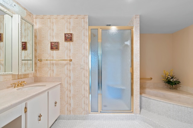 bathroom with tile walls, a shower with door, tile floors, and vanity