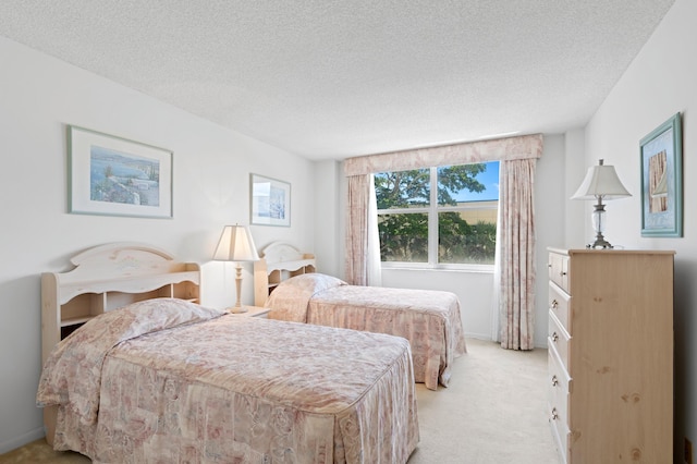 bedroom with carpet and a textured ceiling