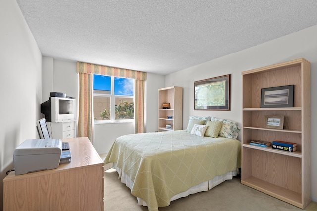 bedroom featuring light colored carpet and a textured ceiling