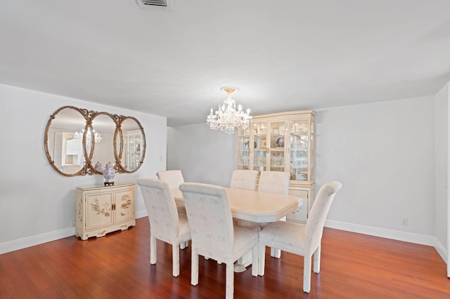 dining area with a chandelier and hardwood / wood-style flooring