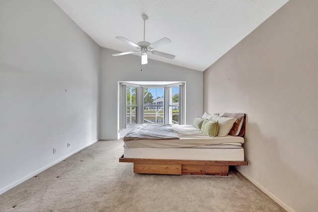 carpeted bedroom featuring lofted ceiling and ceiling fan