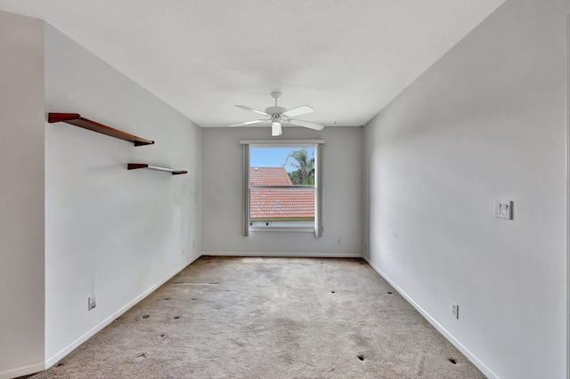 unfurnished room featuring ceiling fan and light carpet