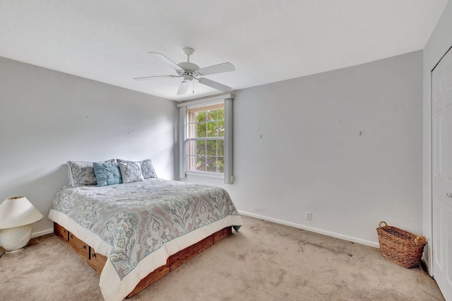 bedroom featuring ceiling fan and light carpet