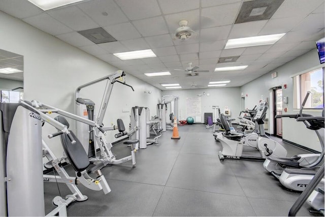 gym featuring ceiling fan and a paneled ceiling