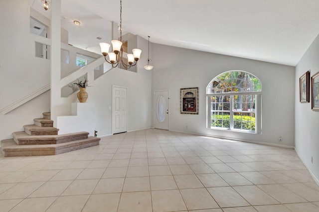 interior space with high vaulted ceiling, a notable chandelier, and light tile flooring