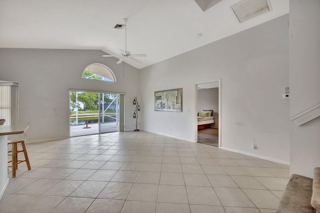 unfurnished room with ceiling fan, high vaulted ceiling, and light tile floors