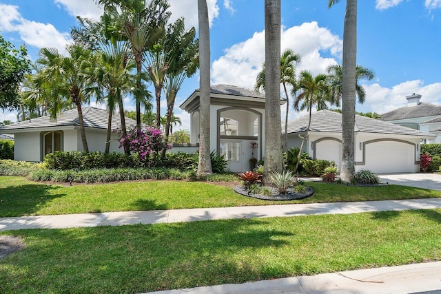 view of front facade with a garage and a front lawn