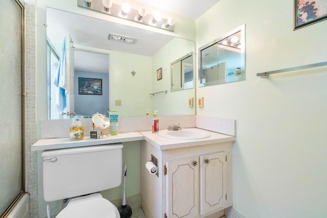 full bathroom featuring combined bath / shower with glass door, oversized vanity, and toilet