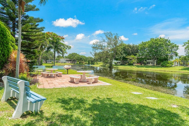 view of yard with a water view and a patio area