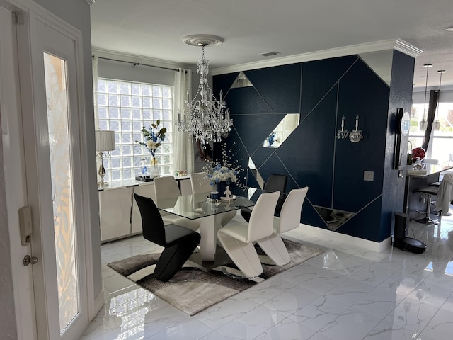 dining area with marble finish floor, crown molding, and a chandelier