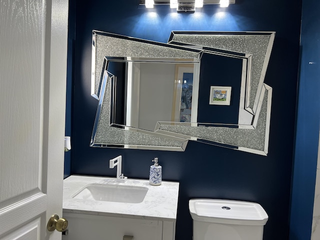 bathroom with toilet and vanity