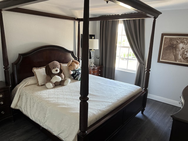 bedroom with baseboards and dark wood-style floors