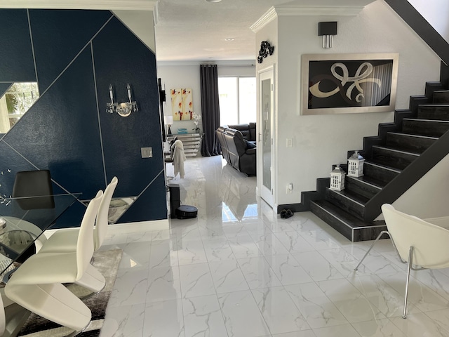 interior space with marble finish floor, baseboards, and ornamental molding